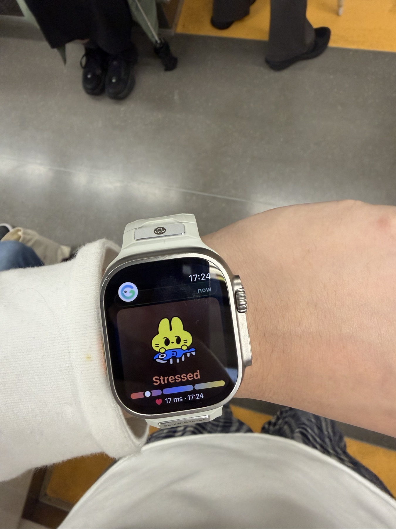 An Apple Watch showing a stressed mood check-in while riding a train.